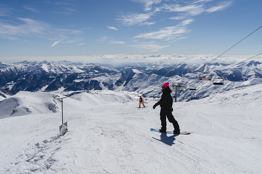 Gudauri, Georgia - February 16, 2016: Snowboarders are about to slide down the slope of the Gudauri ski resort, Georgia.