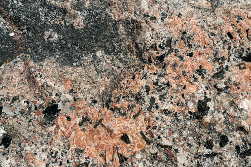 background texture of red and black granite close-up. pattern for desktop design