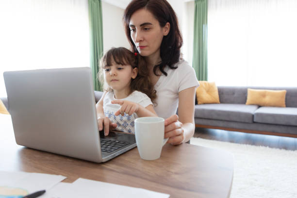 istock Young mother working and spending time with her daughter 1227594488