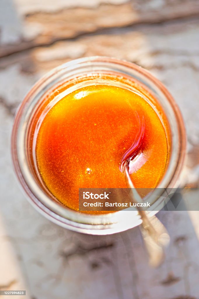 Manuka honey in the jar with spoon, morning sunlight Leptospermum Scoparium Stock Photo