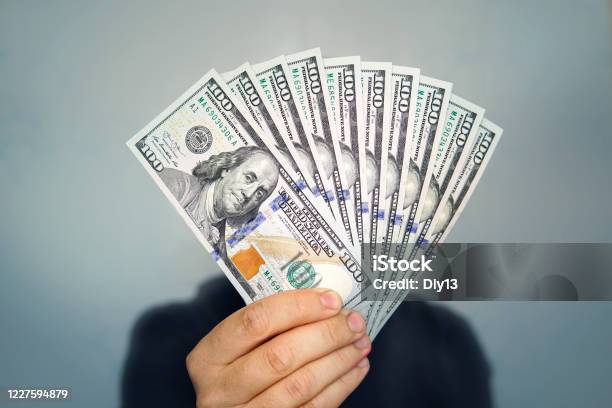 1000 Dollars In 100 Bills In A Mans Hand Closeup On A Dark Background Hands Holding Dollar Cash Stock Photo - Download Image Now