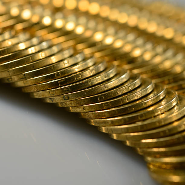 filas de monedas de oro se encuentran en la mesa. - token gold coin treasure fotografías e imágenes de stock