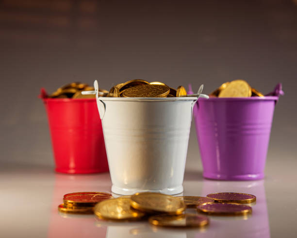 three buckets filled with golden coins.