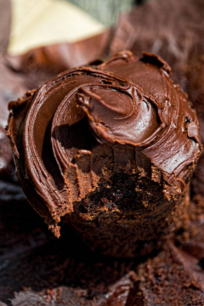 istock Chocolate muffin with chocolate icing on top, bite taken 1227595974