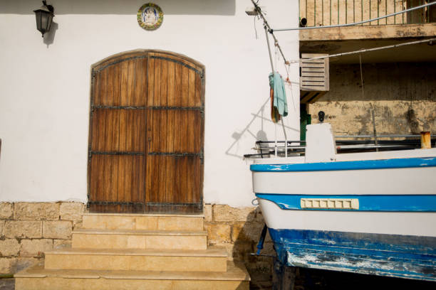 istock Old wooden door and blue boat 1227596242