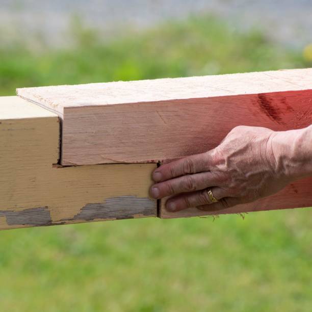 istock Old Farmhouse Beam is Repaired. Man’s Hand, negative copy space 1227597804