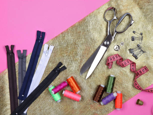 istock Set of tailoring tools and accessories on golden fabric. Top view, flat lay 1227597817
