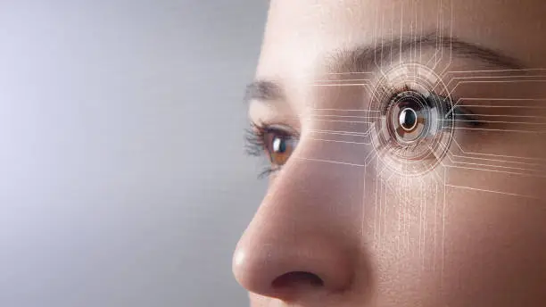 Modern cyber woman with technolgy eye looking. The young woman 's eye is close-up. The concept of the new technology is iris recognition.