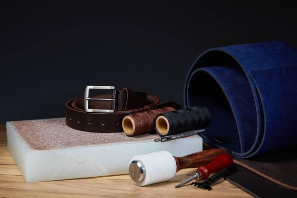 istock Leather crafting tools with handmade belt on a used Die Cutting Board. 1227599385