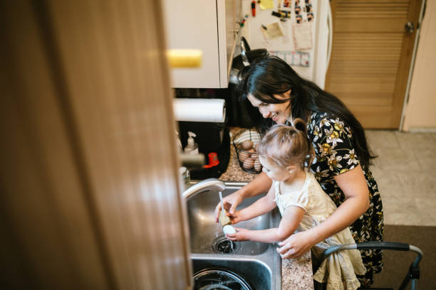 istock Mother and Daughter Wash Freshly Collected Chicken Eggs 1227602713