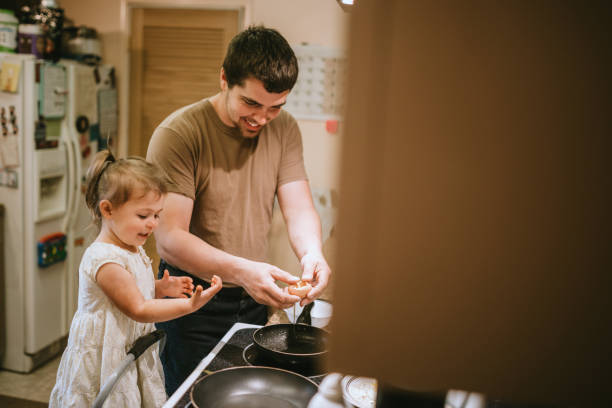 istock Father and Daughter Cooking Breakfast Together 1227602728