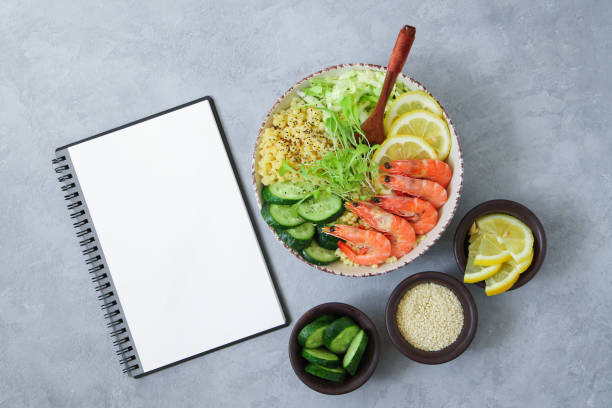 istock Balanced and healthy Buddha Bowl and blank notepad top view on light gray stone table. Ingredients for trend salad 1227602773