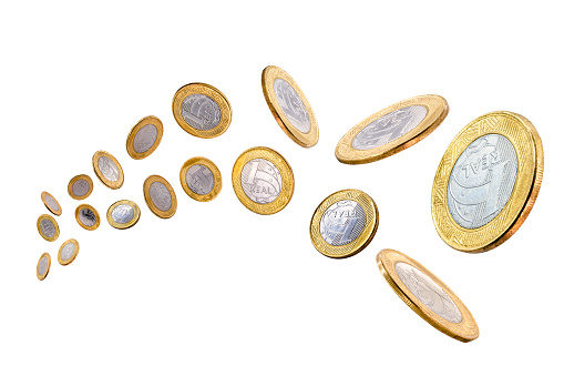 Front view of a group of stacks of golden coins arranged side by side in ascending height order isolated on a white background.