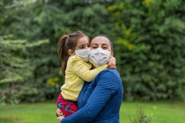 istock Responsible Mother and Young Daughter Wearing Face Masks 1227603185