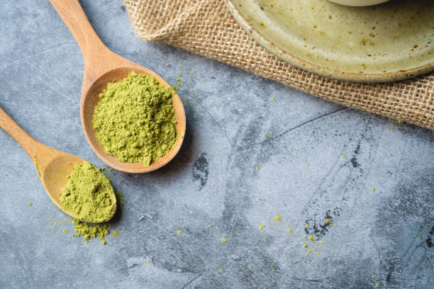 istock Green tea matcha powder on a  wooden spoon. 1227603200