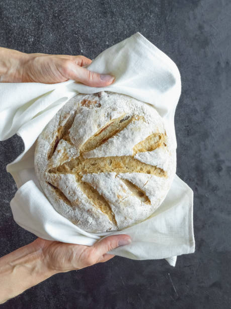 istock No knead baked bread in a hand 1227603824