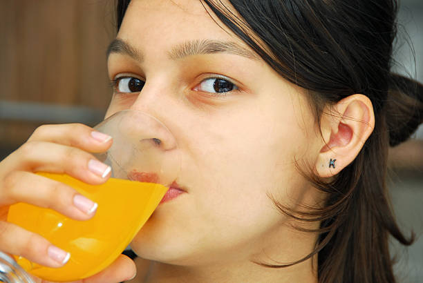 istock Girl portrait drinking juice 122760403