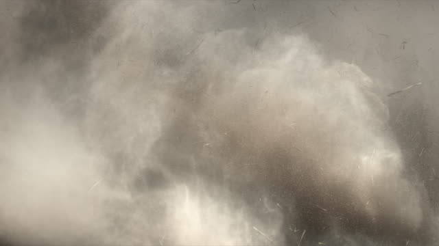 4K Dust and hay explosion cloud descedning in slow-motion