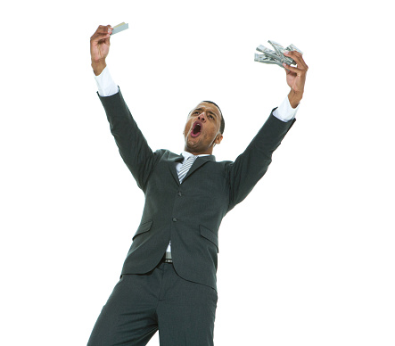 Portrait of aged 20-29 years old african-american ethnicity young male business person standing in front of white background wearing businesswear who is happy who is buying and holding credit card