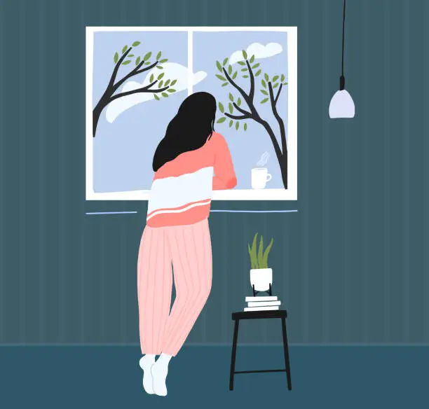 Vector illustration of Young woman at home longing at window. Spring landscape outside, blue sky with clouds and trees. Cozy pink pajama. Self isolation concept illustration.