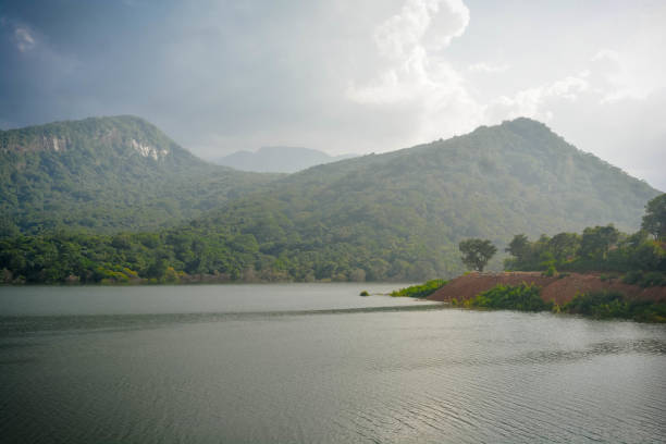 Natural water reservoir near mountains with full of greenery.