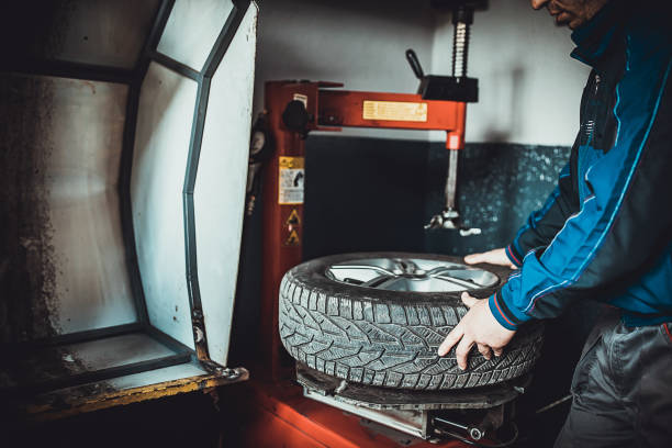 istock Male mechanic replacing wheel tire and balancing it 1227612410