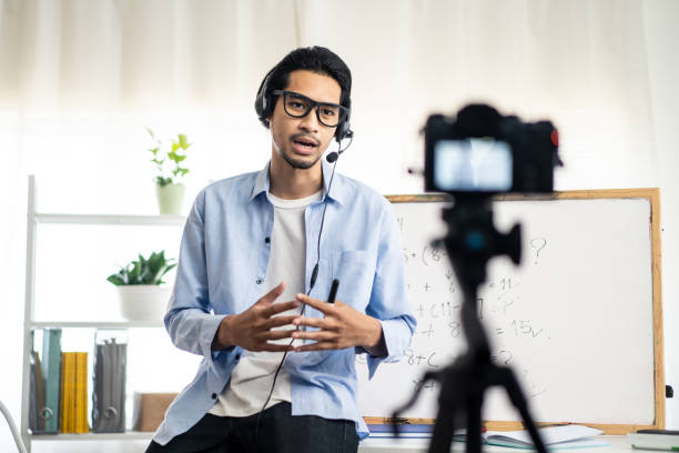 istock Asian school male teacher working from home teaching online math subject to student studying from home. Man using camera to record his live on internet. Remote education class during covid19 pandemic. 1227613282