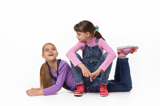 children girls laughing sitting on green grass park