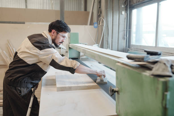 istock Young factory worker using mechanic handtool to smoothe surface of workpiece 1227614033
