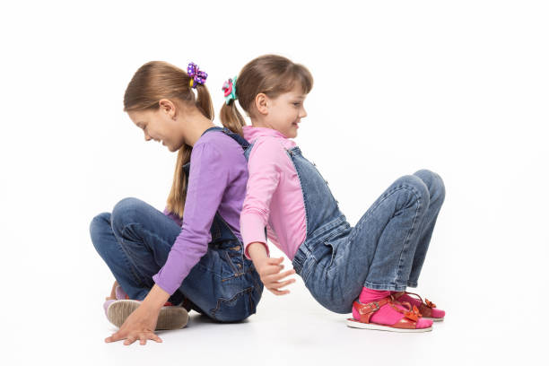 Pretty girls sitting on the floor and playing