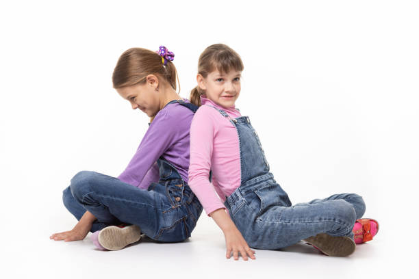 istock Sisters quarreling pushing each other's backs 1227614168