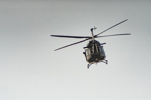 Silhouette of S Soviet helicopter Mi-8 common operational military aircraft aloft in the air cloudy sky