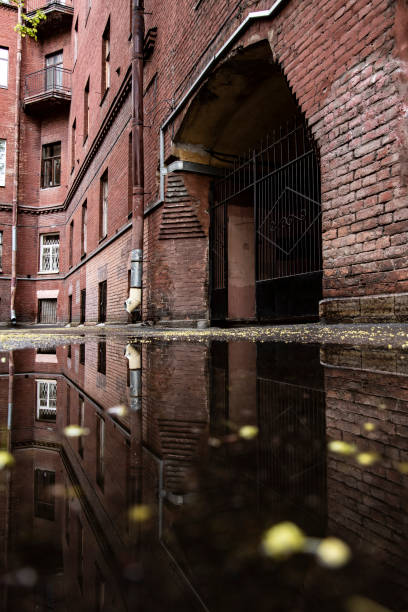istock Old courtyards in the reflections of puddles 1227617765