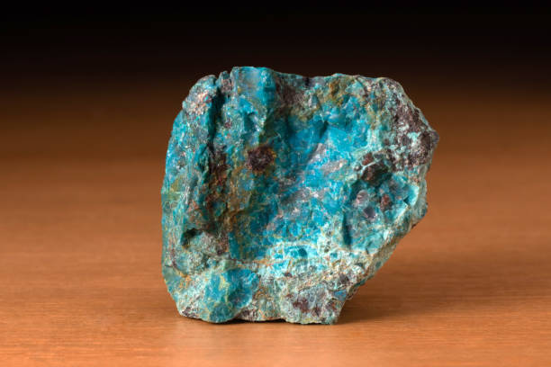 istock Rock of Chrysocolla mineral from Peru over a wooden table 1227617823