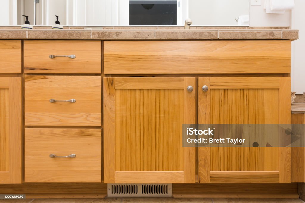Front face of new wooden cabinetry Oil finished wooden cabinetry in home bathroom Bathroom Stock Photo