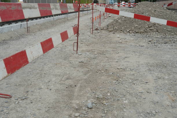 istock ground prepared for civil engineering building site bordered by construction barrier planks of red and white color 1227619120