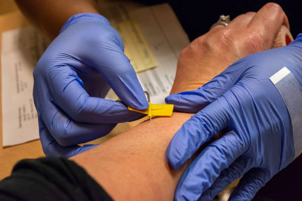 Inserting a Hypodermic Needle Using Butterfly / Winged Setup stock photo