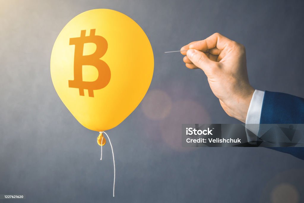 Bitcoin cryptocurrency symbol on yellow balloon. Man hold needle directed to air balloon. Concept of finance risk Bitcoin cryptocurrency symbol on yellow balloon. Man hold needle directed to air balloon. Concept of finance risk. Bitcoin Stock Photo