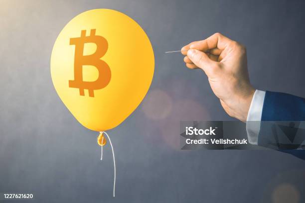Bitcoin Cryptocurrency Symbol On Yellow Balloon Man Hold Needle Directed To Air Balloon Concept Of Finance Risk Stock Photo - Download Image Now