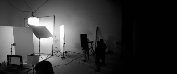 istock Shooting studio for photographer and creative art director with production crew team setting up lighting flash and LED headlight on tripod and professional equipment for portrait model photo shoot and video online filming 1227622062