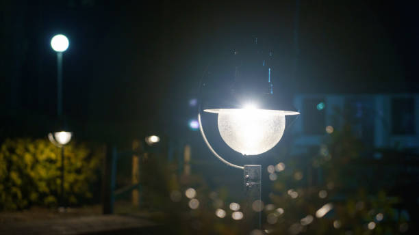 istock The backdrop is Bush that little light. Magic street lamp close-up with copyspace. Warm lantern light on a night background. 1227627703