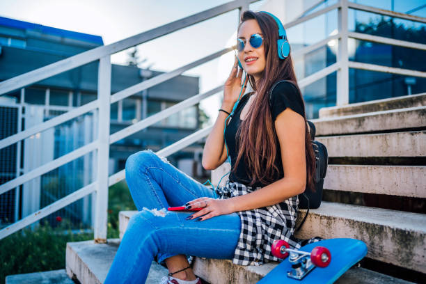 istock Smiling girl with skateboard 1227628189