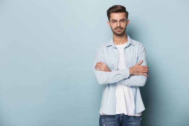 istock Confident young man standing near blank empty copy space. 1227629281