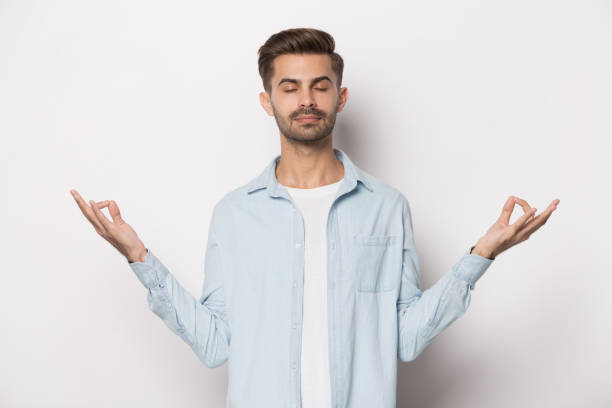istock Young peaceful guy doing breathing yoga exercises. 1227629293