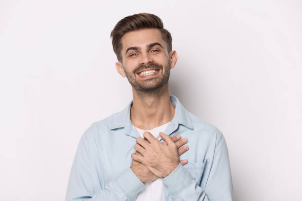 istock Happy thankful smiling young man feeling grateful. 1227629299
