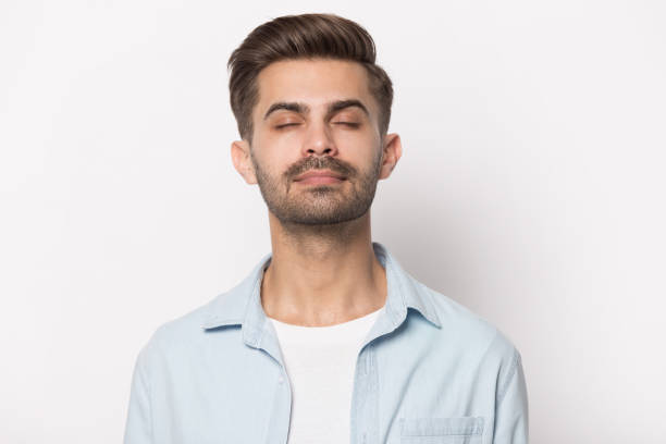 istock Close up young calm man calming down, relaxing. 1227629303