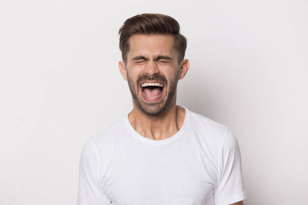 istock Angry stressed outraged hysterical millennial guy screaming. 1227629316