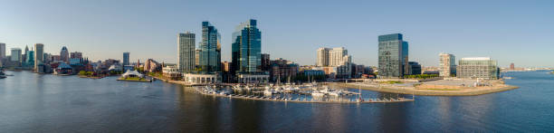 the aerial panorama of inner harbor and harbor east residential district and marina at patapasco river in baltimore, maryland, usa, at sunset. - baltimore maryland inner harbor skyline imagens e fotografias de stock