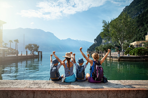 Family enjoying vacations in Italy. They are sitting in the harbour of beautiful city of Riva del Garda and enjoying view of Lake Garda surrounded my mountains.
Nikon D850