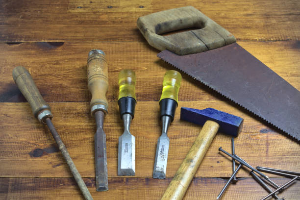 istock basic carpenter's tools, such as handsaw, rasps, chisels, on a wooden board 1227631842